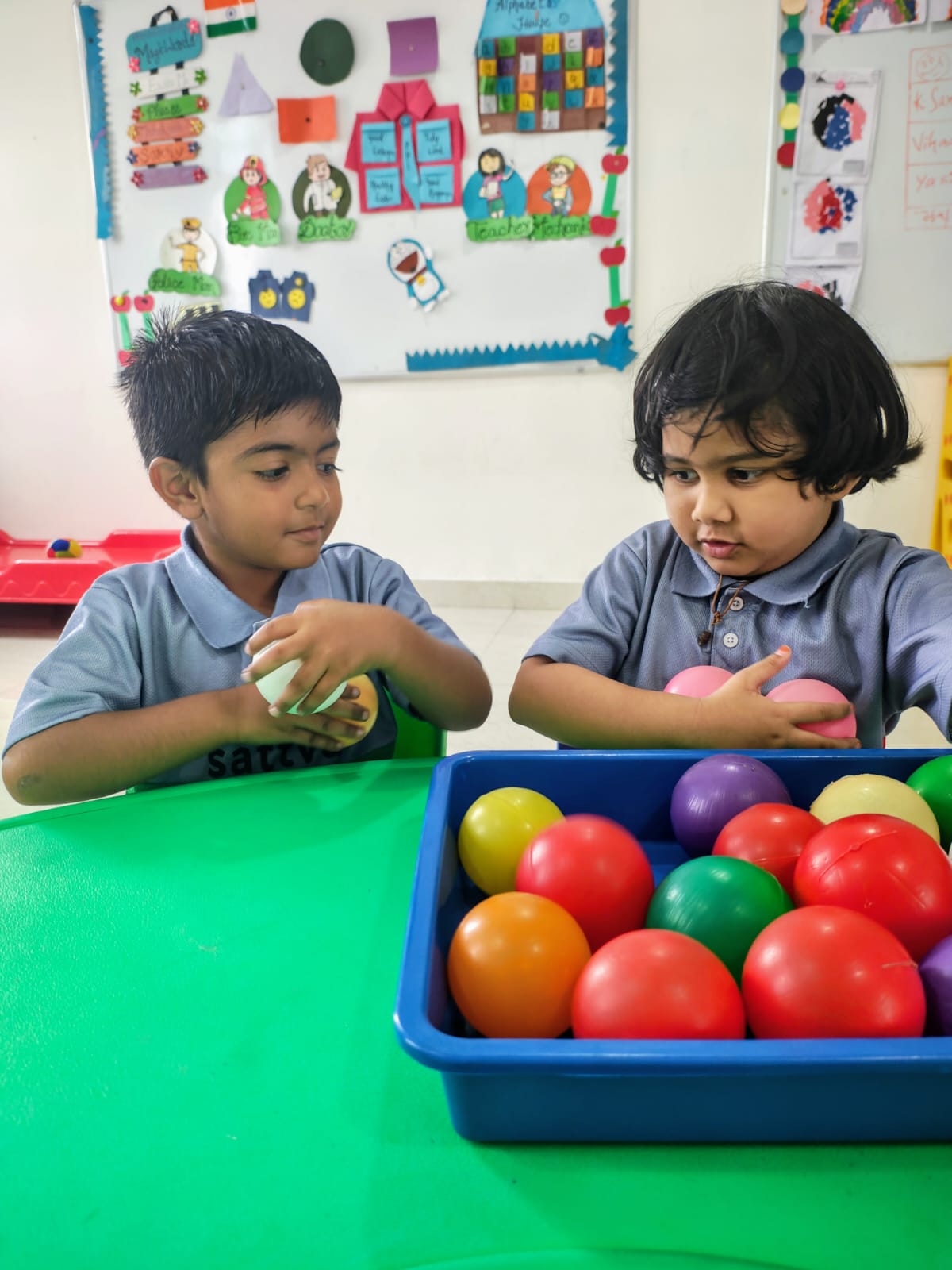 Two Early Years children at a ball tray in the Nursery room