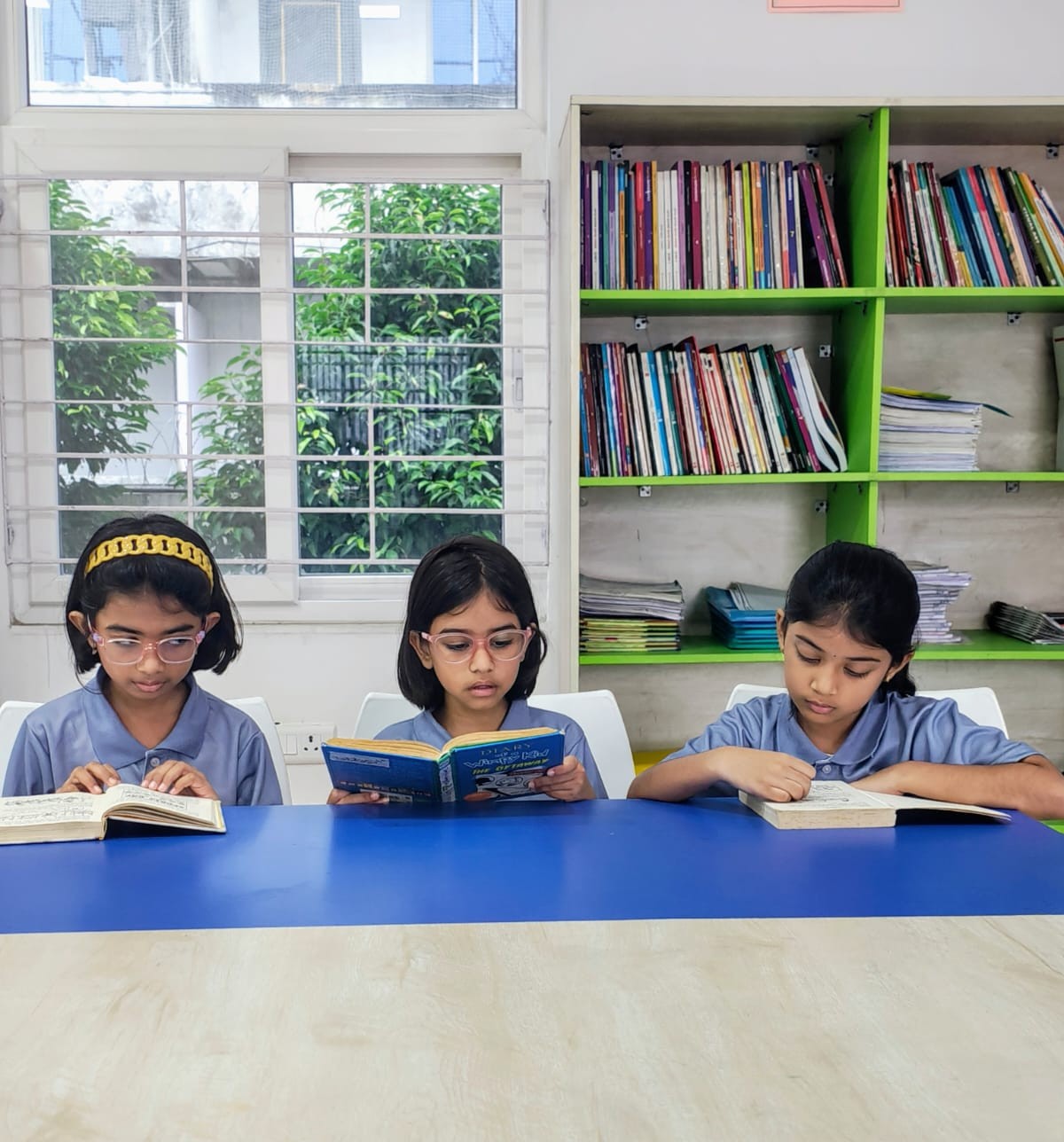Secondary School students reading together in the library